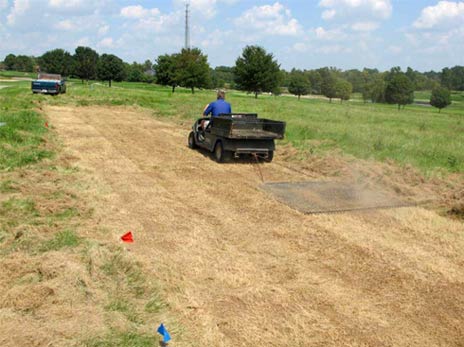 Image of a lawncare operator establishing habitat by dragging soil.